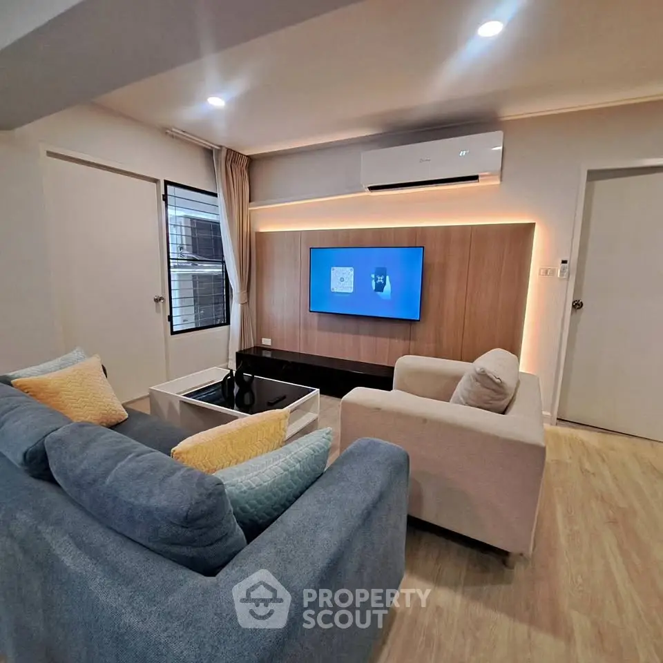 Modern living room with stylish furniture and wall-mounted TV