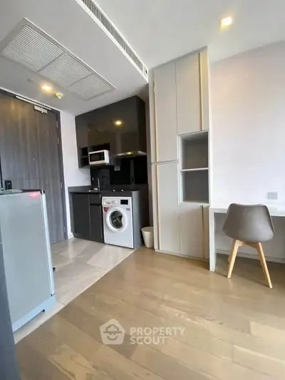 Modern compact kitchen with washing machine and sleek cabinetry