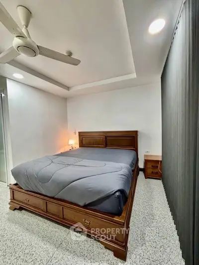 Cozy bedroom with modern ceiling fan and elegant wooden bed frame