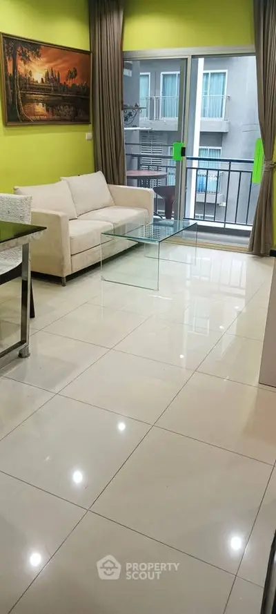 Modern living room with bright walls, sleek furniture, and balcony access in urban apartment.