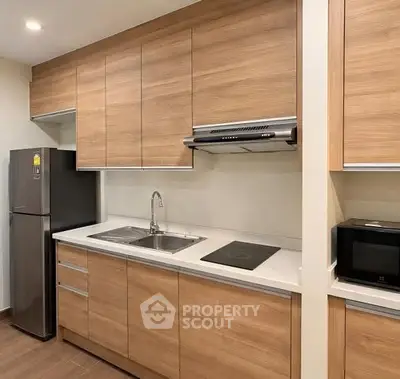 Modern kitchen with sleek wooden cabinets and stainless steel appliances