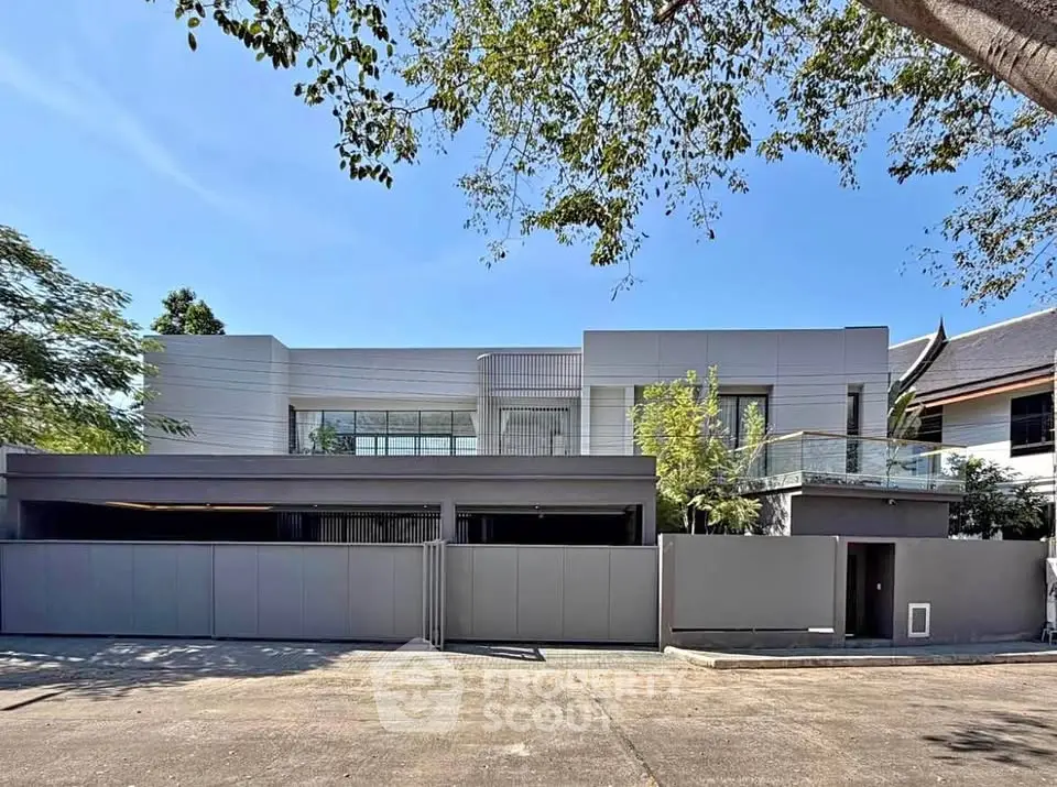 Modern luxury home with sleek design and spacious balcony in a serene neighborhood.