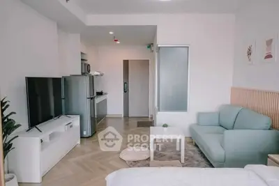 Modern open-plan living room with sleek kitchen and cozy seating area.