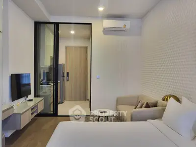 Modern studio apartment with cozy living area and sleek kitchen