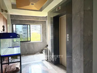 Modern building interior with elevator and large window view