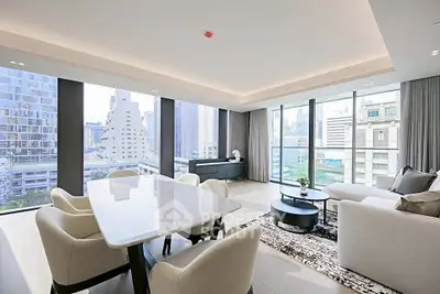 Luxurious modern living room with panoramic city views and elegant furnishings.
