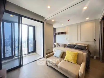 Modern studio apartment with balcony and city view, featuring cozy living area and stylish decor.
