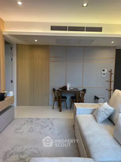 Modern living room with cozy seating and elegant dining area