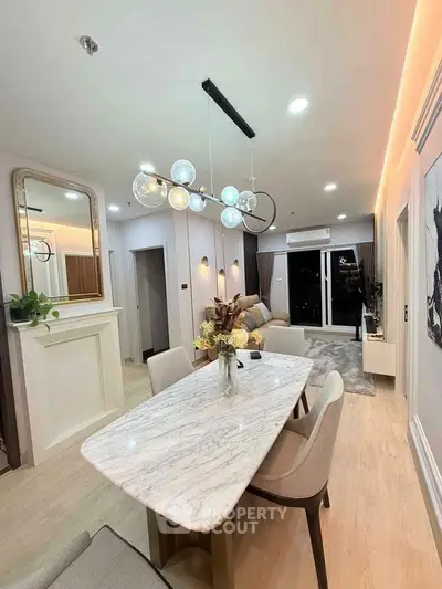 Modern living room with elegant dining area and stylish lighting in a contemporary apartment.