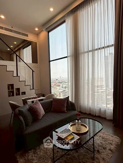 Luxurious high-rise living room with floor-to-ceiling windows and stunning city view.