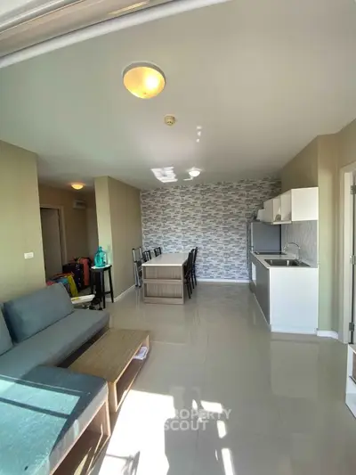 Spacious modern living room with open kitchen and stylish decor