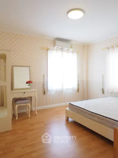 Bright bedroom with wooden flooring and elegant decor