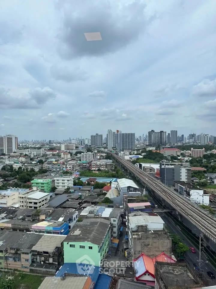 Stunning cityscape view showcasing urban skyline and railway from a high vantage point.