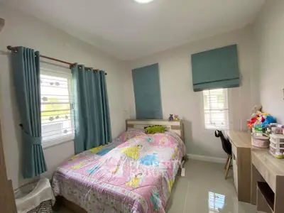 Charming bedroom with cozy decor and natural light, perfect for relaxation and comfort.