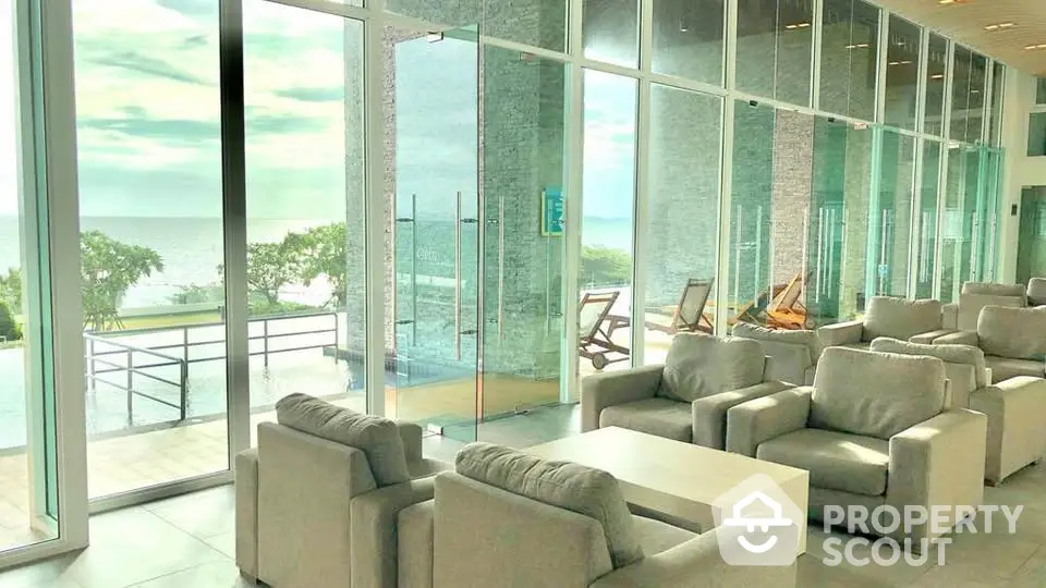 Luxurious beachfront lounge with panoramic ocean views and modern seating area.