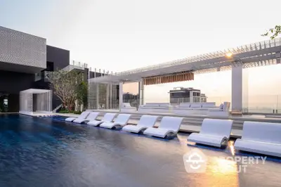 Luxurious rooftop pool with modern lounge chairs and stunning city view