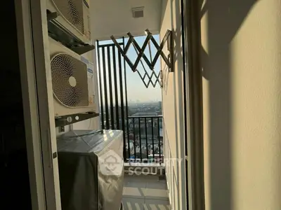 Compact balcony with city view and air conditioning units, perfect for urban living.