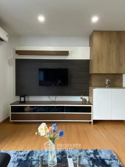 Modern living room with stylish TV unit and wooden flooring, perfect for cozy family gatherings.