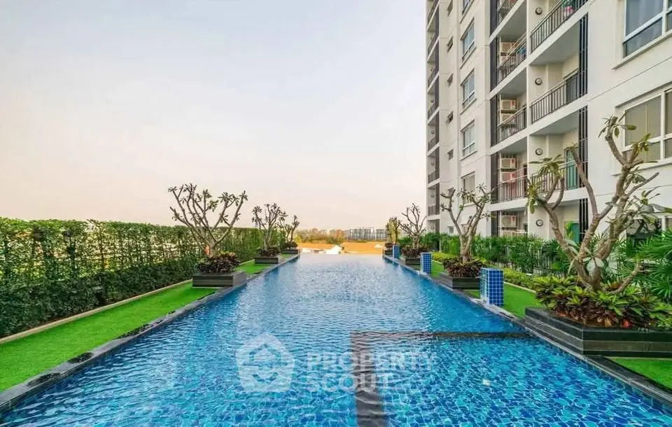 Luxurious apartment building with stunning pool and lush greenery