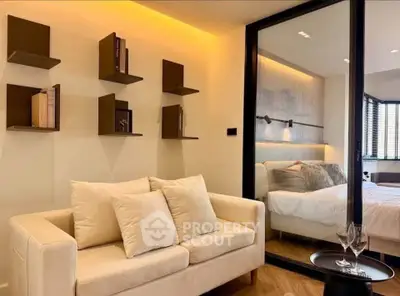 Modern living room with cozy sofa and stylish bedroom view