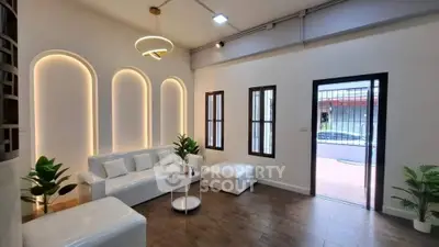 Modern living room with stylish lighting and white furniture