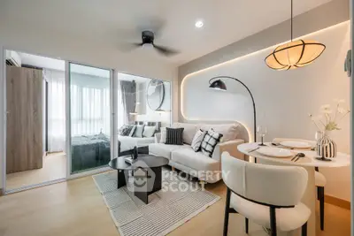Modern living room with stylish decor and open layout, featuring cozy seating and elegant lighting.