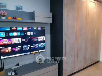 Modern living room with sleek entertainment unit and stylish storage cabinets.