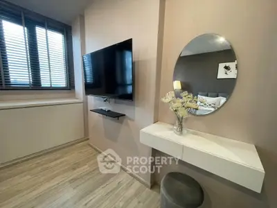 Modern bedroom with wall-mounted TV and stylish decor