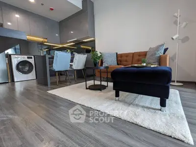 Chic modern living space with elegant furnishings, sleek hardwood floors, and a convenient in-unit washer, perfect for urban living.