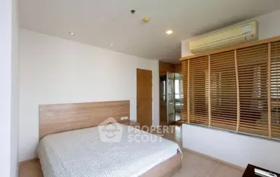 Modern bedroom with minimalist design and air conditioning in a stylish apartment.