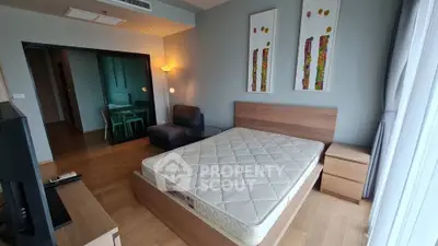 Spacious bedroom with modern decor and natural light in a stylish apartment.