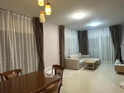 Spacious living room with elegant curtains and modern furniture