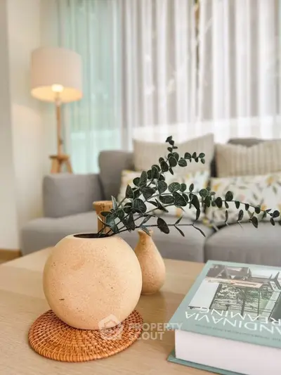 Stylish living room with cozy sofa, elegant decor, and natural light creating a warm ambiance.