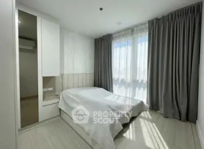 Bright and modern bedroom with large window and elegant curtains