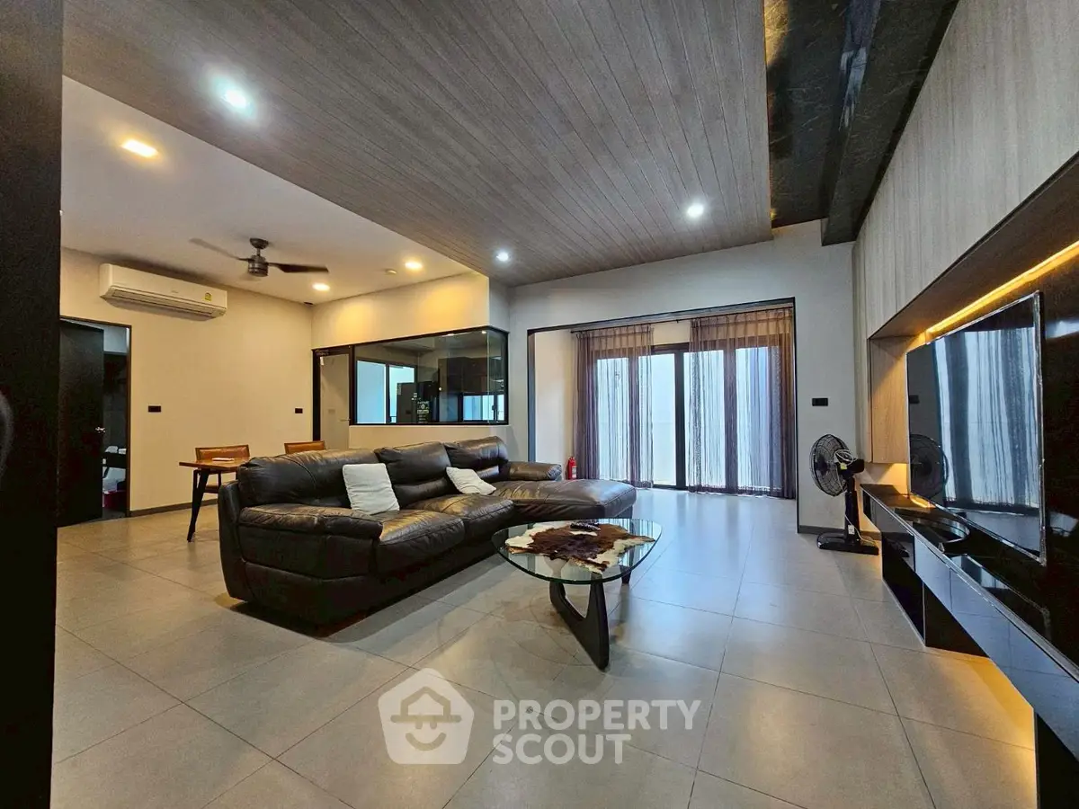 Spacious modern living room with sleek design and ample natural light