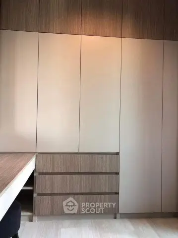 Modern built-in wardrobe with sleek wooden finish in a stylish interior space.