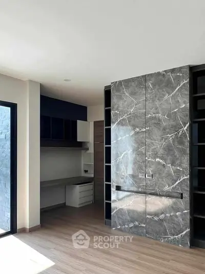 Modern study room with marble accent wall and built-in desk