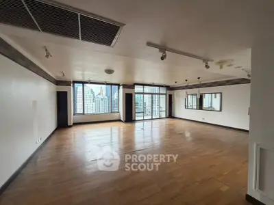 Spacious corner unit living room with city view and large windows