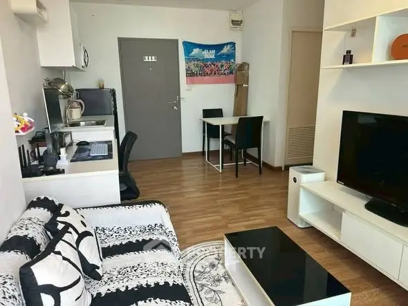 Modern living room with stylish decor and open layout, featuring a cozy sofa and entertainment center.