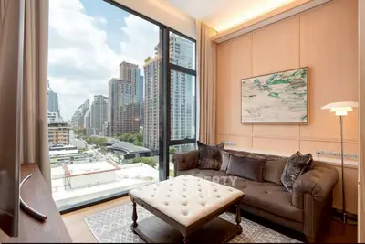 Luxurious living room with stunning city view, featuring elegant sofa and large window in modern apartment.