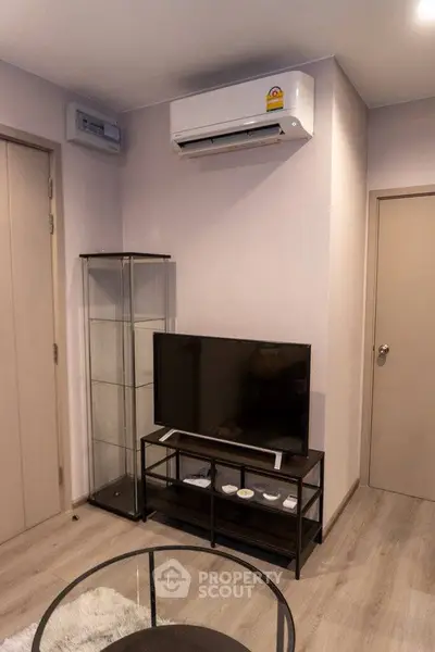 Modern living room with sleek TV setup and air conditioning