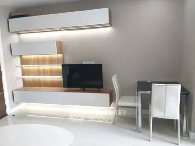 Modern living room with sleek furniture and built-in TV unit, perfect for contemporary living.