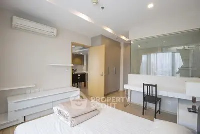 Modern bedroom with air conditioning and study area in stylish apartment.
