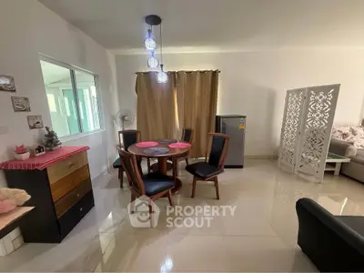 Modern dining area with elegant furniture and stylish decor in a spacious living room.