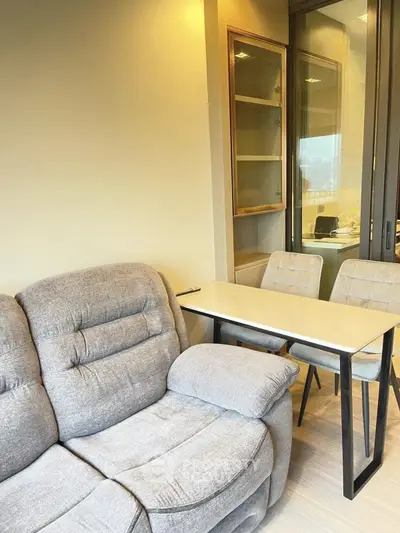 Modern living room with cozy sofa and stylish dining area in a bright apartment.