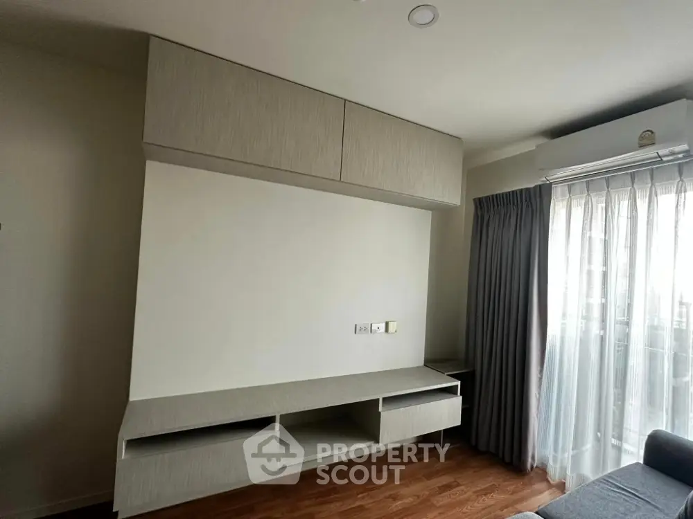 Modern living room with built-in storage and natural light