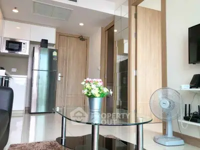 Modern apartment interior with glass coffee table and sleek kitchen appliances
