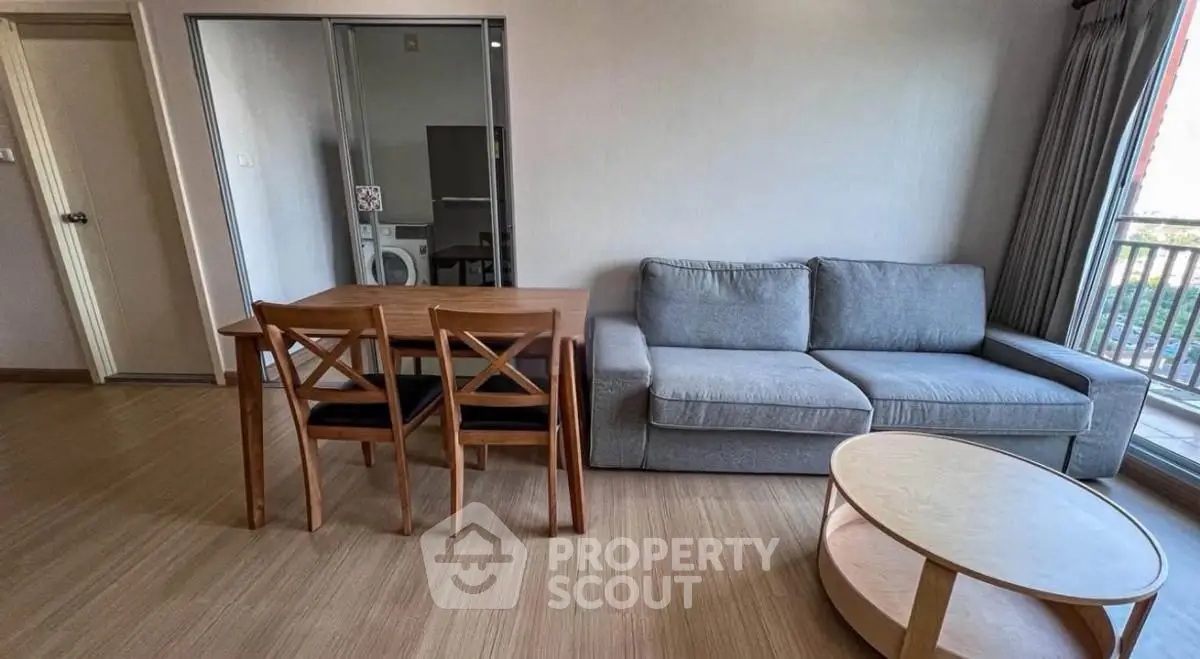 Spacious living room with modern furniture and balcony view
