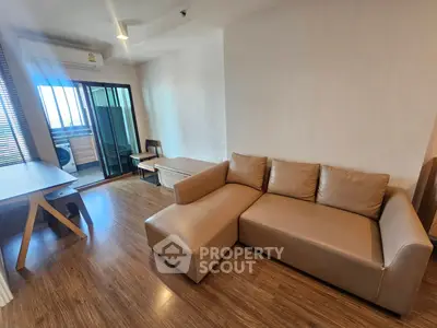 Modern living room with stylish sofa and balcony view