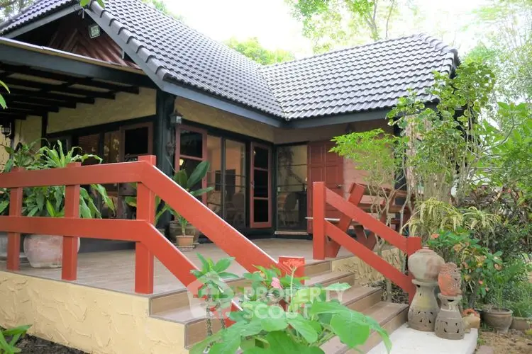 Charming tropical bungalow with lush garden and inviting entrance